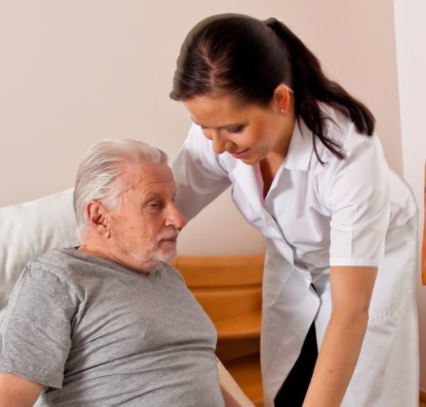 Caregiver assiting an old man