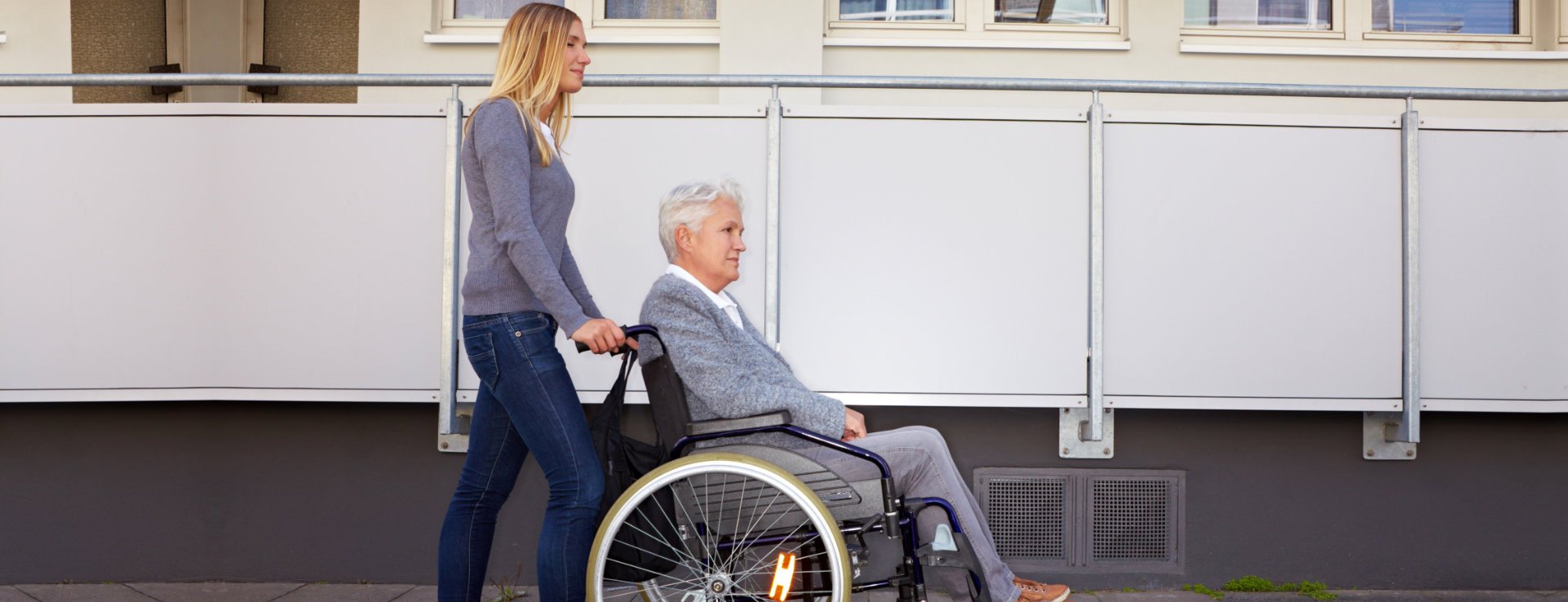Caregiver assisting an elderly woman